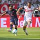 hilipp Mwene of Mainz, left, and Stuttgart's Enzo Millot challenge for the ball during the German Bundesliga soccer match between Stuttgart and Mainz in Stuttgart, Germany, Saturday, Aug. 31, 2024. (Jan-Philipp Strobel/dpa via AP)