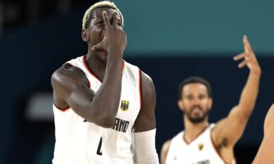 Germany's Isaac Bonga, left, and Germany's Nick Weiler-Babb gesture after scoring during a men's basketball game against Greece at the 2024 Summer Olympics, Tuesday, Aug. 6, 2024, in Villeneuve-d'Ascq, France. (AP Photo/Michael Conroy)