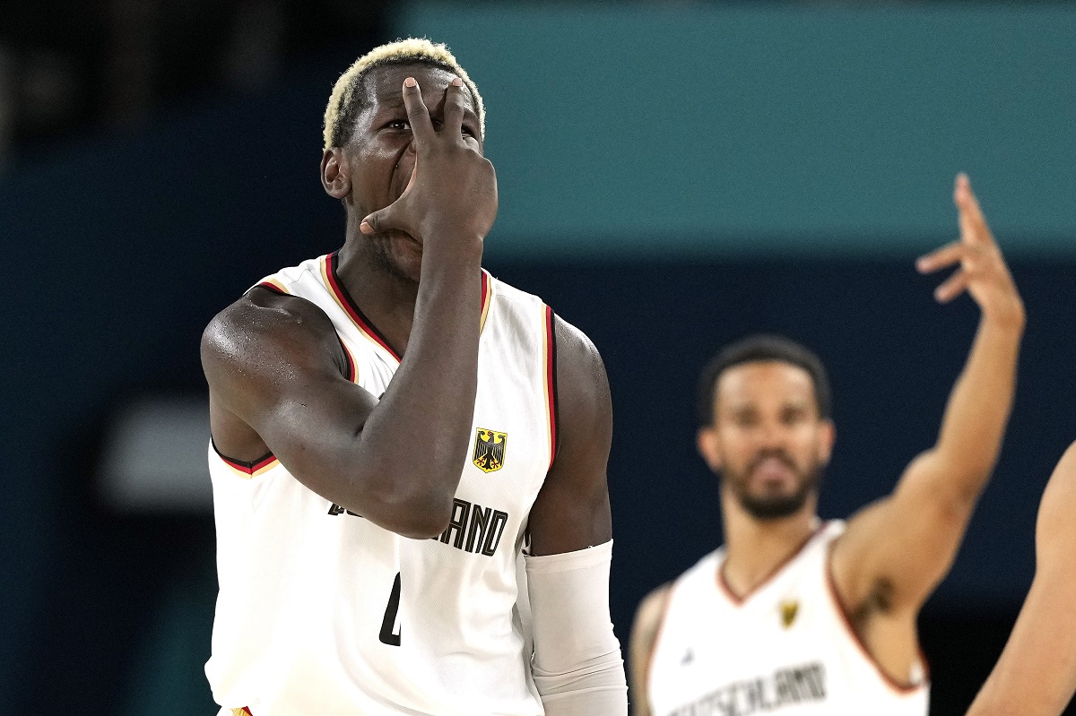 Germany's Isaac Bonga, left, and Germany's Nick Weiler-Babb gesture after scoring during a men's basketball game against Greece at the 2024 Summer Olympics, Tuesday, Aug. 6, 2024, in Villeneuve-d'Ascq, France. (AP Photo/Michael Conroy)