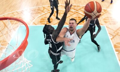 Serbia's Nikola Jokic, right, shoots as South Sudan's Wenyen Gabriel defends during a men's basketball game at the 2024 Summer Olympics, Saturday, Aug. 3, 2024, in Villeneuve-d'Ascq, France. (AP Photo/Michael Conroy, Pool)