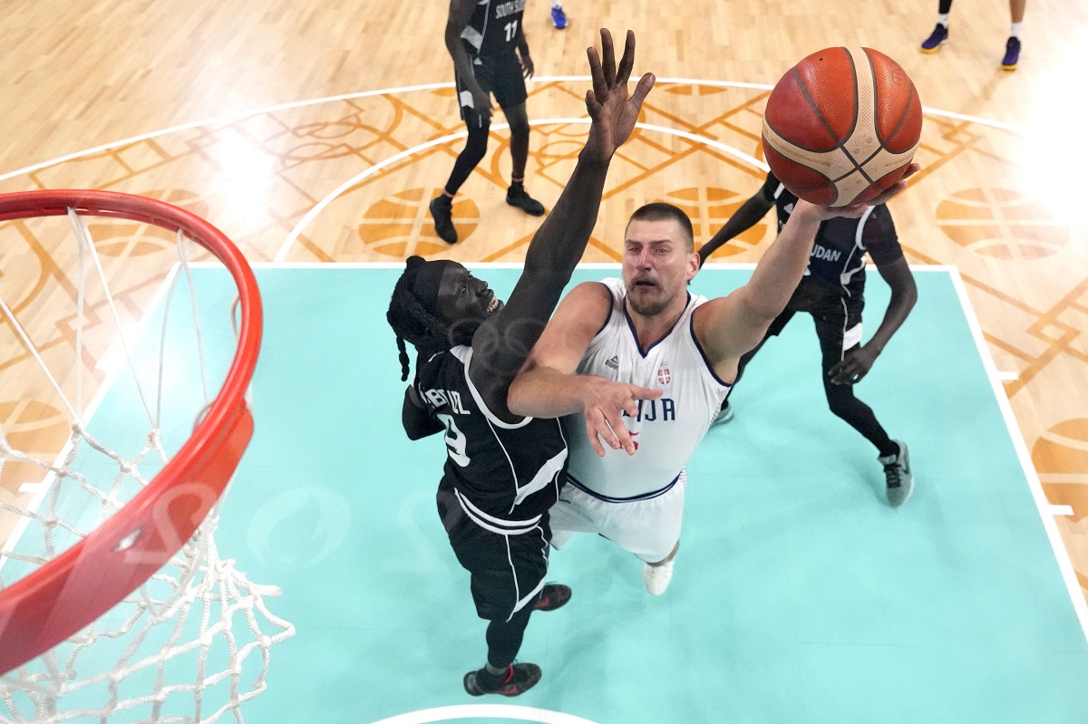 Serbia's Nikola Jokic, right, shoots as South Sudan's Wenyen Gabriel defends during a men's basketball game at the 2024 Summer Olympics, Saturday, Aug. 3, 2024, in Villeneuve-d'Ascq, France. (AP Photo/Michael Conroy, Pool)