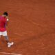 Novak Djokovic of Serbia celebrates after defeating Lorenzo Musetti of Italy in their men's singles semifinals tennis match, at the 2024 Summer Olympics, Friday, Aug. 2, 2024, at the Roland Garros stadium in Paris, France. (AP Photo/Manu Fernandez)
