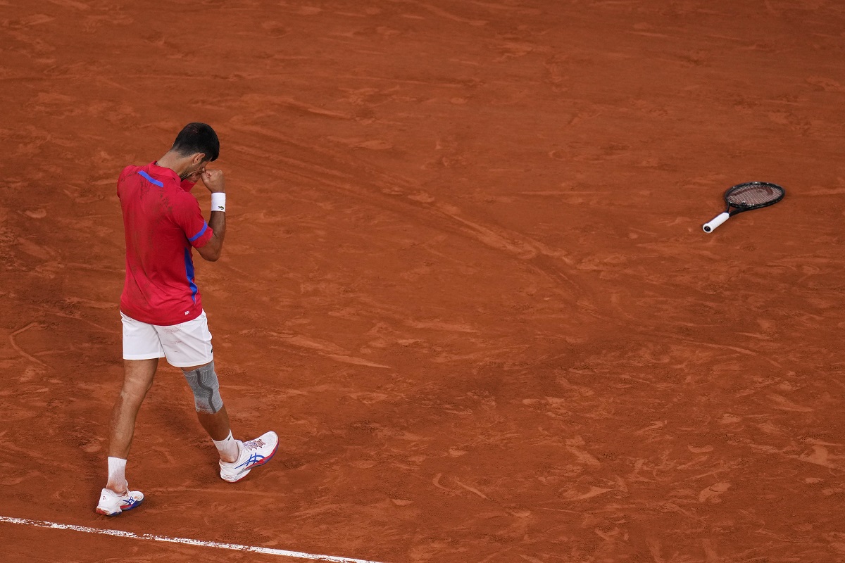 Novak Djokovic of Serbia celebrates after defeating Lorenzo Musetti of Italy in their men's singles semifinals tennis match, at the 2024 Summer Olympics, Friday, Aug. 2, 2024, at the Roland Garros stadium in Paris, France. (AP Photo/Manu Fernandez)