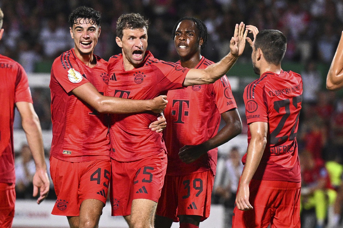 Bayern Munich's Thomas Müller, second from left, celebrates after scoring a goal during a DFB Cup first round soccer match against Ulm, Friday, Aug. 16, 2024, in Ulm, Germany. (Tom Weller/dpa via AP)