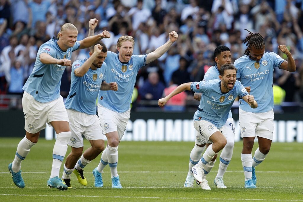 Manchester City players celebrate winning the FA Community Shield soccer match between Manchester City and Manchester United by penalty shootout at Wembley Stadium in London, Saturday, Aug. 10, 2024. (AP Photo/David Cliff)