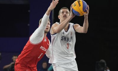 Serbia's Strahinja Stojacic (3) drives past Poland's Przemyslaw Zamojski (8) in the women's 3x3 basketball pool round match during the 2024 Summer Olympics, Friday, Aug. 2, 2024, in Paris, France. Serbia won 21-12. (AP Photo/Frank Franklin II)