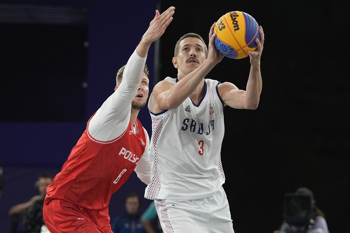 Serbia's Strahinja Stojacic (3) drives past Poland's Przemyslaw Zamojski (8) in the women's 3x3 basketball pool round match during the 2024 Summer Olympics, Friday, Aug. 2, 2024, in Paris, France. Serbia won 21-12. (AP Photo/Frank Franklin II)