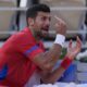 Novak Djokovic of Serbia reacts during a break as he plays against Lorenzo Musetti of Italy during their men's singles semifinals tennis match, at the 2024 Summer Olympics, Friday, Aug. 2, 2024, at the Roland Garros stadium in Paris, France. (AP Photo/Andy Wong)