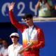 Spain's Carlos Alcaraz waves with his silver medal after losing to Serbia's Novak Djokovic in the men's singles tennis final at the Roland Garros stadium during the 2024 Summer Olympics, Sunday, Aug. 4, 2024, in Paris, France. Djokovic has won his first Olympic gold medal by beating Alcaraz 7-6 (3), 7-6 (2) in the 2024 Games men's tennis singles final. (AP Photo/Manu Fernandez)