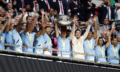 Manchester City midfielder Kevin De Bruyne lifts the trophy after his team won the FA Community Shield soccer match between Manchester City and Manchester United at Wembley Stadium in London, Saturday, Aug. 10, 2024. (AP Photo/David Cliff)