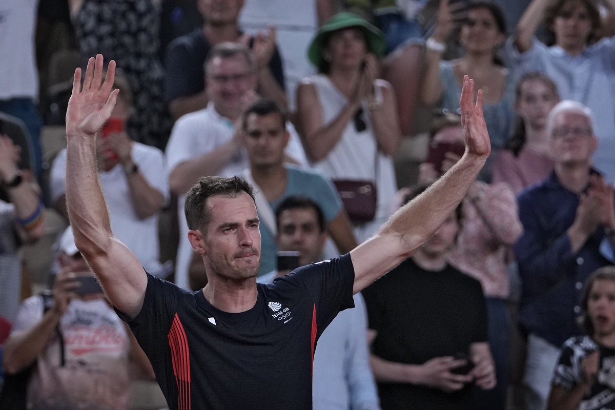 Andy Murray of Britain cries and waves to the spectators after he and his partner Daniel Evans defeated by Taylor Fritz and Tommy Paul of the United States in the men's doubles quarterfinals tennis match, at the 2024 Summer Olympics, Thursday, Aug.1, 2024, at the Roland Garros stadium in Paris, France. (AP Photo/Andy Wong)