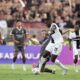 Parma's Ange Yoan Bonny, right, fights for the ball with Milan's Strahinja Pavlovic during the Italian Serie A soccer match between Parma and Milan at Parma's Ennio Tardini Stadium in Parma, Italy, Saturday Aug. 24, 2024. (Massimo Paolone/LaPresse via AP)