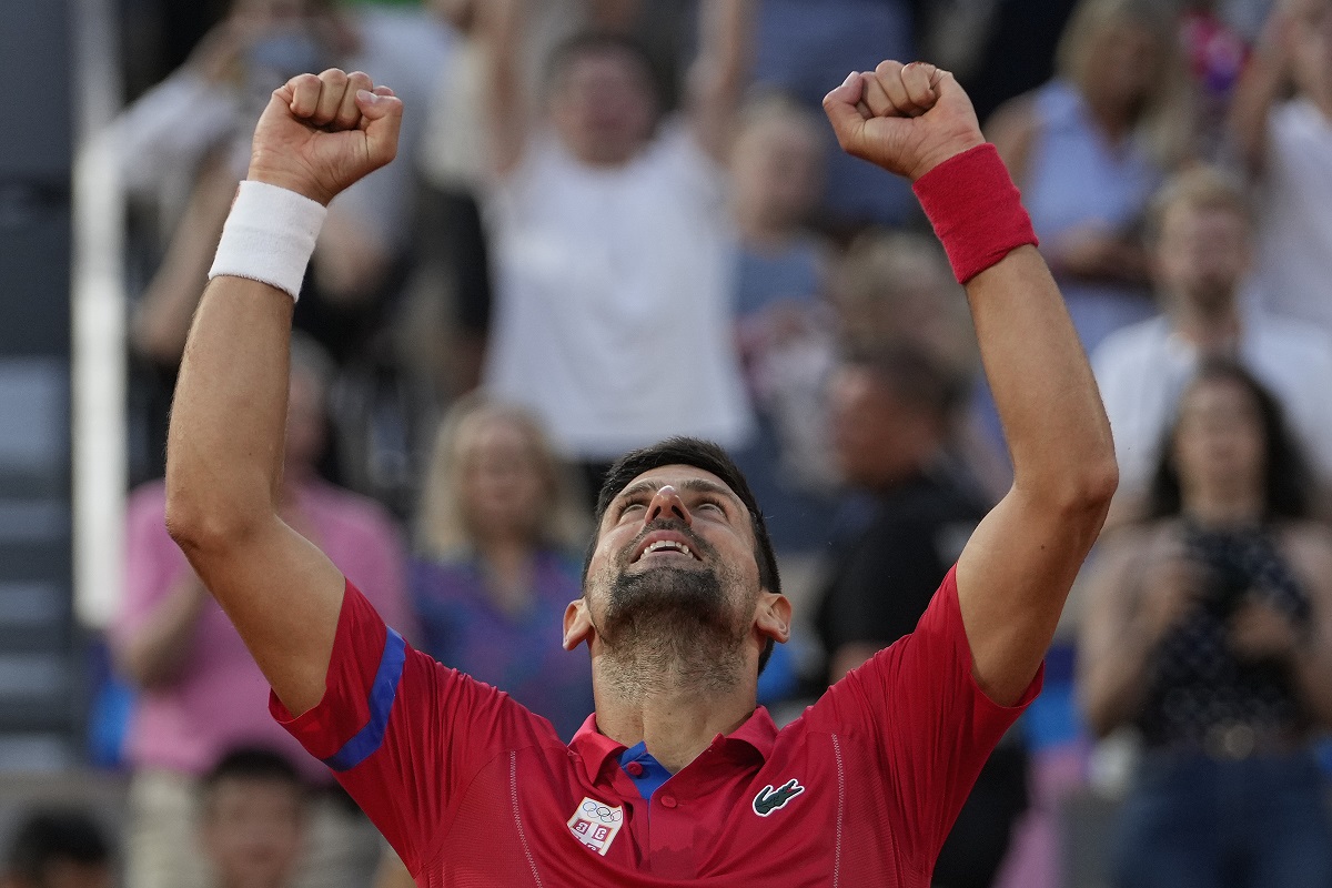 Novak Djokovic of Serbia celebrates after defeating Lorenzo Musetti of Italy in their men's singles semifinals tennis match, at the 2024 Summer Olympics, Friday, Aug. 2, 2024, at the Roland Garros stadium in Paris, France. (AP Photo/Andy Wong)