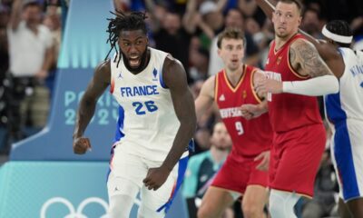 Mathias Lessort (26), of France celebrates a basket against Germany during a men's semifinals basketball game at Bercy Arena at the 2024 Summer Olympics, Thursday, Aug. 8, 2024, in Paris, France. (AP Photo/Mark J. Terrill)