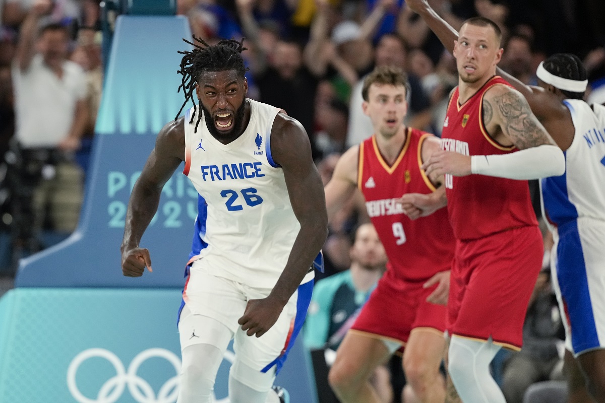 Mathias Lessort (26), of France celebrates a basket against Germany during a men's semifinals basketball game at Bercy Arena at the 2024 Summer Olympics, Thursday, Aug. 8, 2024, in Paris, France. (AP Photo/Mark J. Terrill)