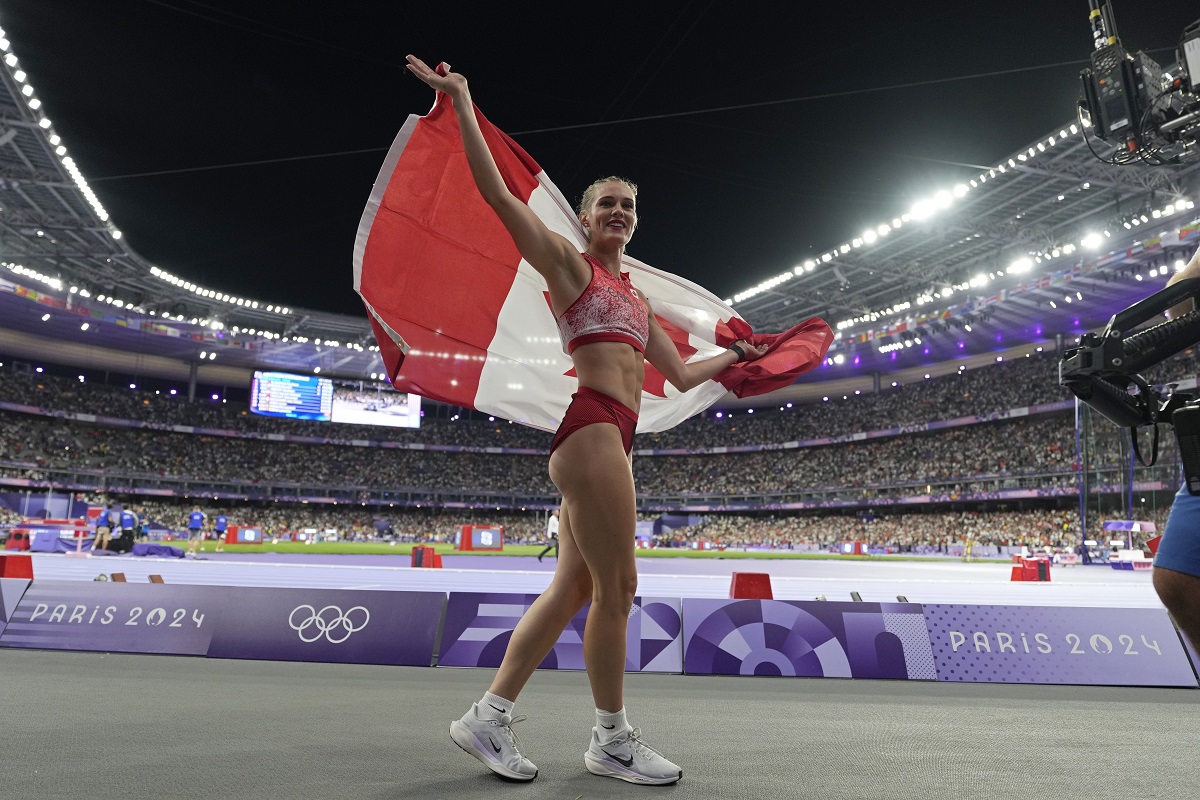 Alysha Newman, of Canada, celebrates after winning the bronze medal in the women's pole vault final at the 2024 Summer Olympics, Wednesday, Aug. 7, 2024, in Saint-Denis, France. (AP Photo/Ashley Landis)