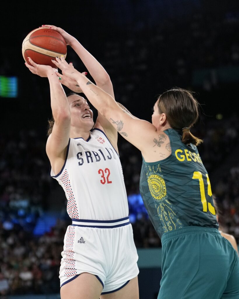 Angela Dugalic (32), of Serbia, shoots over Cayla George (15), of Australia, during a women's quarterfinal game at Bercy Arena at the 2024 Summer Olympics, Wednesday, Aug. 7, 2024, in Paris, France. (AP Photo/Mark J. Terrill)