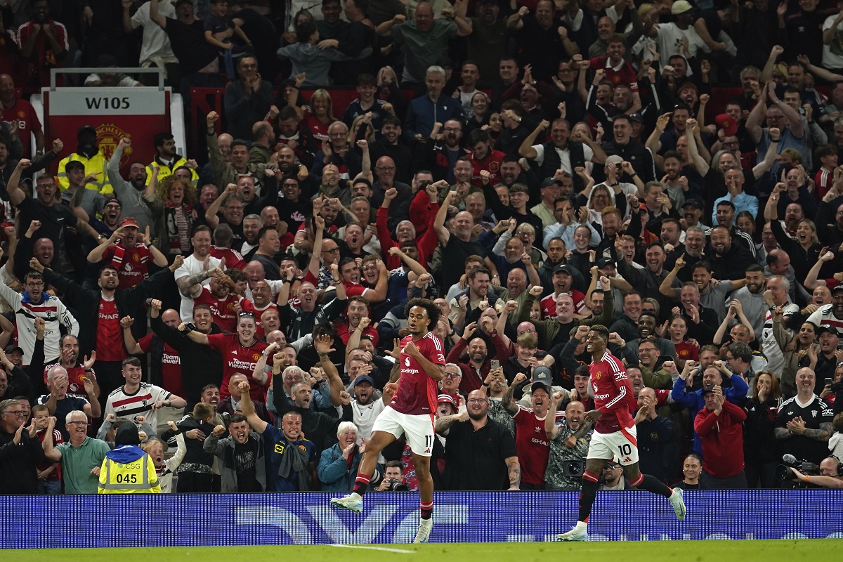 Manchester United's Joshua Zirkzee celebrates after scoring the opening goal during the English Premier League soccer match between Manchester United and Fulham at Old Trafford, Friday, Aug. 16, 2024, in Manchester, England. (AP Photo/Dave Thompson)