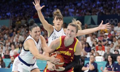 Serbia's Sasa Cadjo, let, ties up Spain's Laura Gil, right, as Serbia's Tina Kajisnik defends during a women's basketball game at the 2024 Summer Olympics, Saturday, Aug. 3, 2024, in Villeneuve-d'Ascq, France. (AP Photo/Michael Conroy)