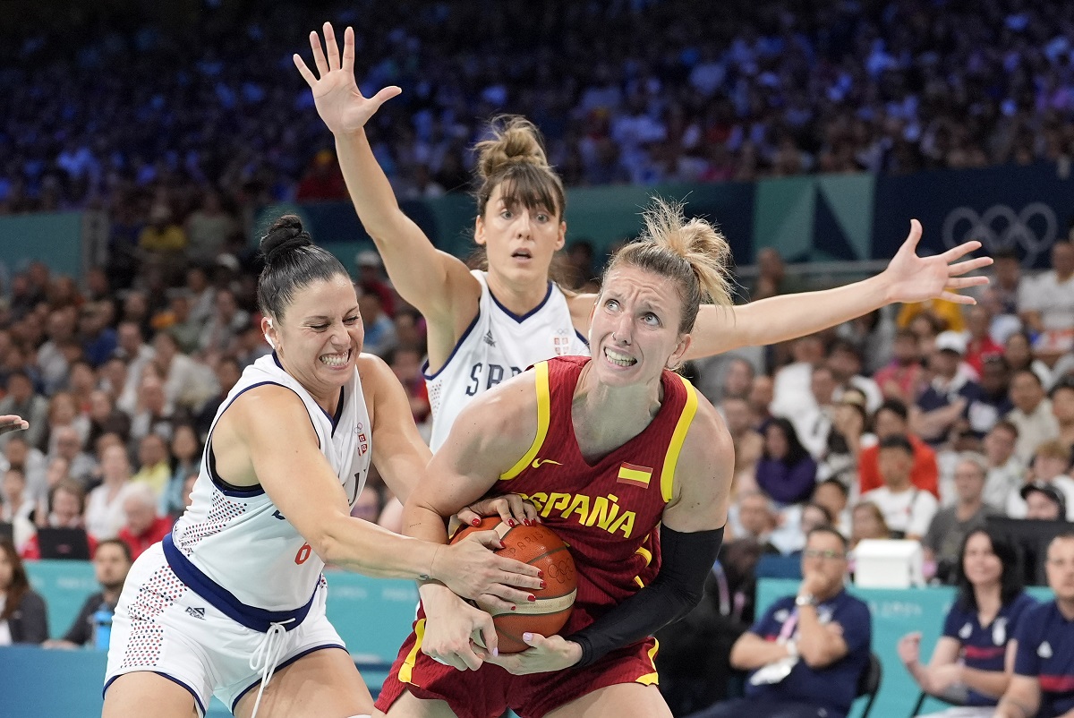 Serbia's Sasa Cadjo, let, ties up Spain's Laura Gil, right, as Serbia's Tina Kajisnik defends during a women's basketball game at the 2024 Summer Olympics, Saturday, Aug. 3, 2024, in Villeneuve-d'Ascq, France. (AP Photo/Michael Conroy)