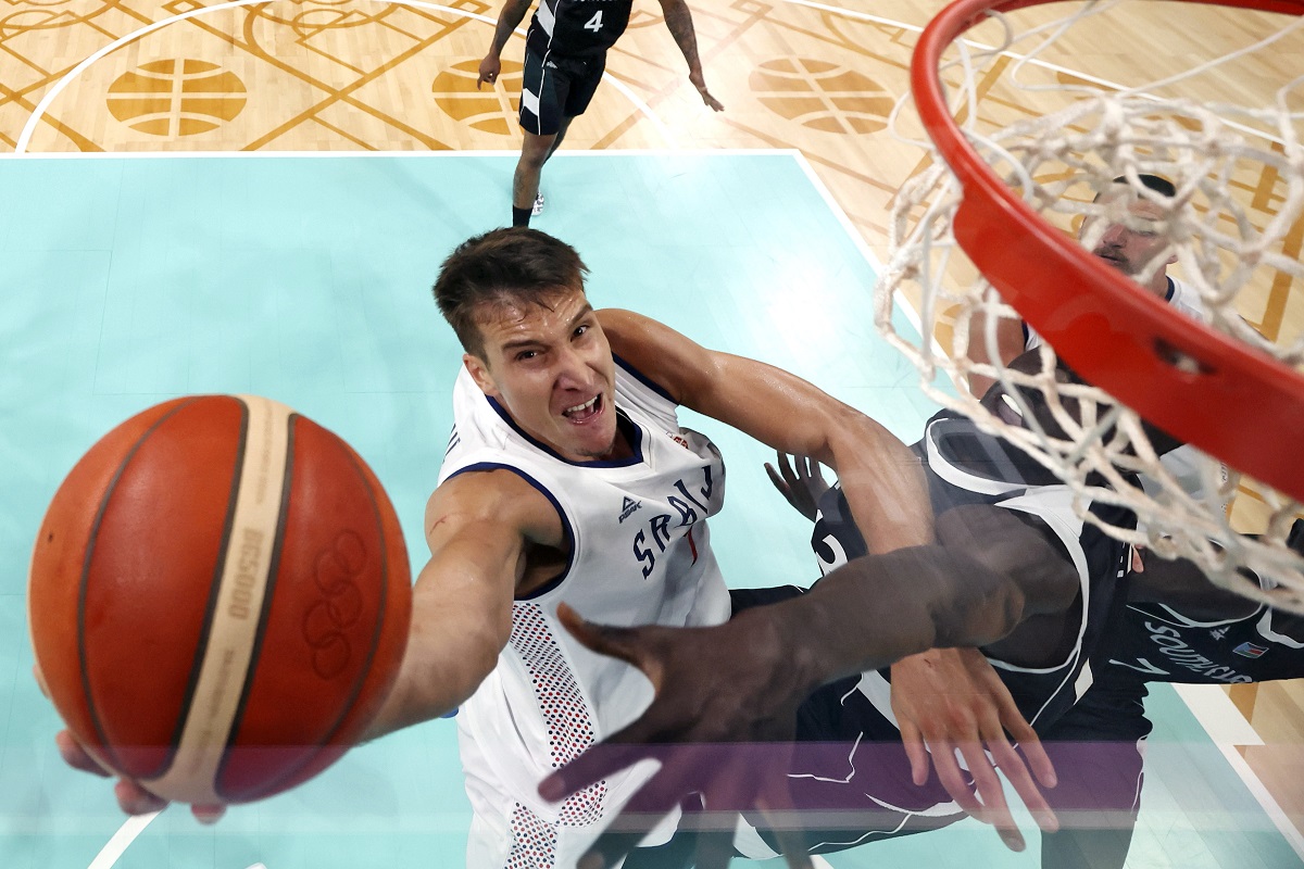 Serbia's Bogdan Bogdanovic, left, shoots as South Sudan's Majok Deng defends during a men's basketball game at the 2024 Summer Olympics, Saturday, Aug. 3, 2024, in Villeneuve-d'Ascq, France. (Gregory Shamus/Pool Photo via AP)