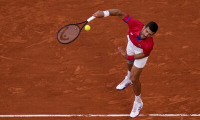 Novak Djokovic of Serbia serves against Lorenzo Musetti of Italy in their men's singles semifinals tennis match, at the 2024 Summer Olympics, Friday, Aug. 2, 2024, at the Roland Garros stadium in Paris, France. (AP Photo/Manu Fernandez)