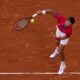 Novak Djokovic of Serbia serves against Lorenzo Musetti of Italy in their men's singles semifinals tennis match, at the 2024 Summer Olympics, Friday, Aug. 2, 2024, at the Roland Garros stadium in Paris, France. (AP Photo/Manu Fernandez)