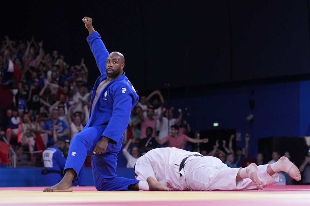 France's Teddy Riner celebrates after defeating Japan's Tatsuru Saito during men's +90 kg of the mixed team final match in the team judo competition, at Champ-de-Mars Arena, during the 2024 Summer Olympics, Saturday, Aug. 3, 2024, in Paris, France. (AP Photo/Eugene Hoshiko)