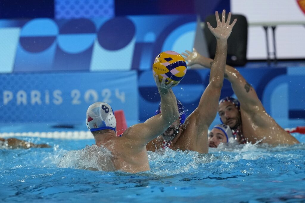 Serbia's Nikola Jaksic shoots to score during a men's water polo Group B preliminary match between Serbia and France, at the 2024 Summer Olympics, Saturday, Aug. 3, 2024, in Saint-Denis, France. (AP Photo/Luca Bruno)