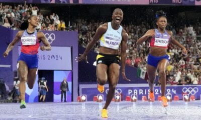 Julien Alfred, of Saint Lucia, celebrates after winning the women's 100-meter final at the 2024 Summer Olympics, Saturday, Aug. 3, 2024, in Saint-Denis, France. (AP Photo/David J. Phillip)