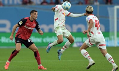 Leverkusen's Granit Xhaka, left, and Leipzig's Xavi Simons battle for the ball during the Bundesliga soccer match between Bayer Leverkusen and RB Leipzig at the BayArena, Leverkusen, Germany, Saturday Aug. 31, 2024. (Federico Gambarini/dpa via AP)