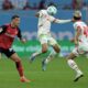 Leverkusen's Granit Xhaka, left, and Leipzig's Xavi Simons battle for the ball during the Bundesliga soccer match between Bayer Leverkusen and RB Leipzig at the BayArena, Leverkusen, Germany, Saturday Aug. 31, 2024. (Federico Gambarini/dpa via AP)