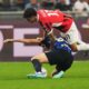 AC Milan's Christian Pulisic, top, and Inter Milan's Alessandro Bastoni challenge for the ball during the Serie A soccer match between Inter Milan and AC Milan at the San Siro stadium in Milan, Italy, Sunday, Sept.22, 2024. (AP Photo/Luca Bruno)