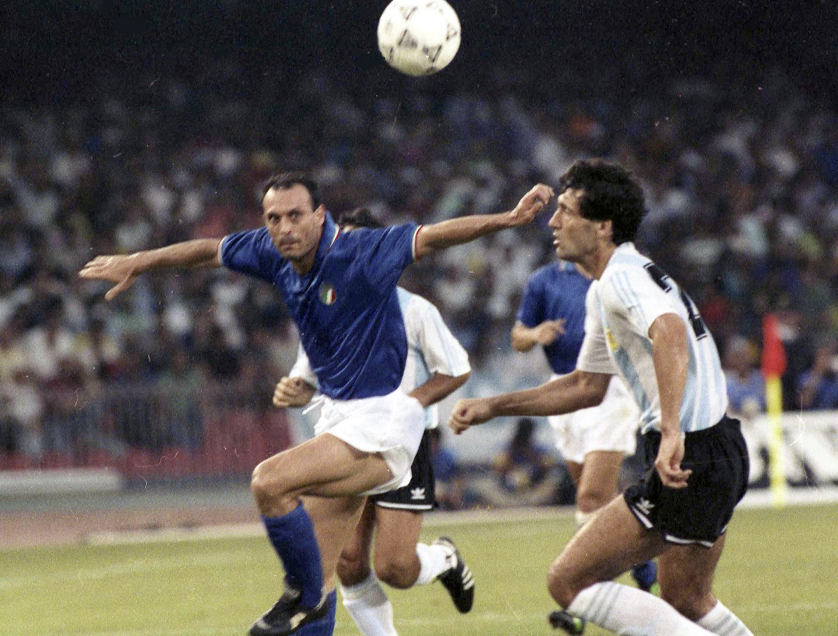 FILE - Italy's Salvatore "Totò" Schillaci, left, and Argentina's Juan Simon chase the ball during the Soccer World Cup semi-final, in Naples, Italy, July 3, 1990. (AP Photo, file)