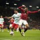 Manchester United's Noussair Mazraoui, right, and Twente's Mitchell van Bergen challenge for the ball during the Europa League opening phase soccer match between Manchester United and Twente in Manchester, England, Wednesday, Sept. 25, 2024. (AP Photo/Dave Thompson)