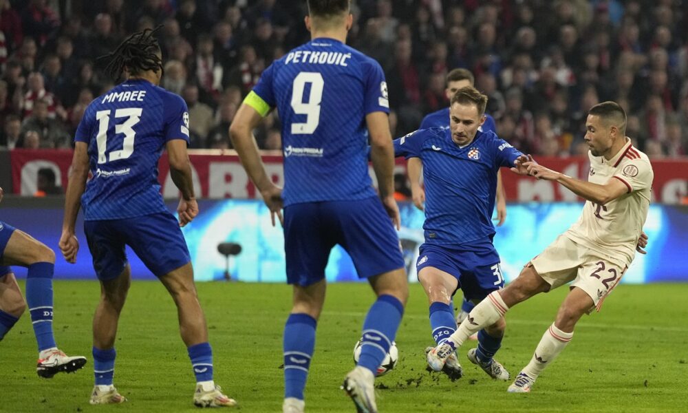 Bayern's Raphael Guerreiro, right shoots at goal during the Champions League opening phase soccer match between Bayern Munich and GNK Dinamo at the Allianz Arena in Munich, Germany Tuesday, Sept. 17, 2024. (AP Photo/Matthias Schrader)