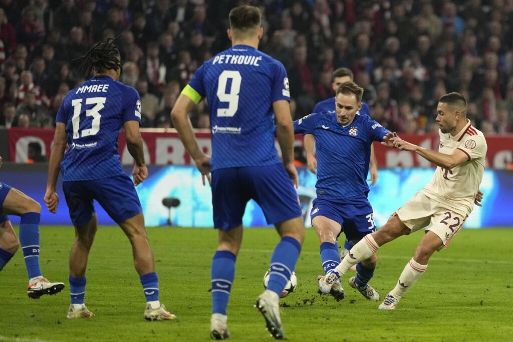 Bayern's Raphael Guerreiro, right shoots at goal during the Champions League opening phase soccer match between Bayern Munich and GNK Dinamo at the Allianz Arena in Munich, Germany Tuesday, Sept. 17, 2024. (AP Photo/Matthias Schrader)