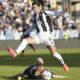 Juventus Dusan Vlahovic, top, is tackled by Empoli's Ardian Ismajli during the Italian Serie A soccer match between Empoli and Juventus at the Carlo Castellani Stadium in Empoli, Italy, Saturday, Sept. 14, 2024. (Marco Bucco/LaPresse via AP)