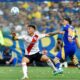 Enzo Diaz, left, of River Plate, and Exequiel Zeballos of Boca Juniors, battle for the ball during an Argentine soccer league match at La Bombonera stadium in Buenos Aires, Argentina, Saturday, Sept. 21, 2024.(AP Photo/Gustavo Garello)