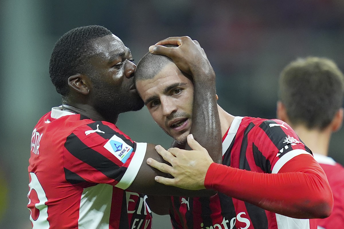 Milan's Alvaro Morata, right, celebrates after scoring the opening goal during the Serie A soccer match between AC Milan and Lecce at the San Siro stadium in Milan, Italy, Friday, Sept. 27, 2024. (Spada/LaPresse via AP)