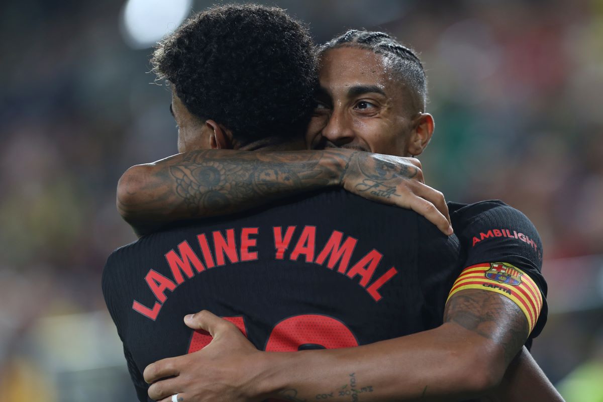 Barcelona's Raphinha celebrates with Lamine Yamal after scoring his side's 4th goal against Villarreal during a Spanish La Liga soccer match at the La Cerámica stadium in Villarreal, Spain, Sunday, Sept. 22, 2024. (AP Photo/Alberto Saiz)