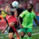 Leverkusen's Alex Grimaldo, left, and Wolfsburg's Ridle Baku fight for the ball during the German Bundesliga soccer match between Bayer Leverkusen and VfL Wolfsburg at the BayArena in Leverkusen, Germany, Sunday, Sept. 22, 2024. (AP Photo/Martin Meissner)