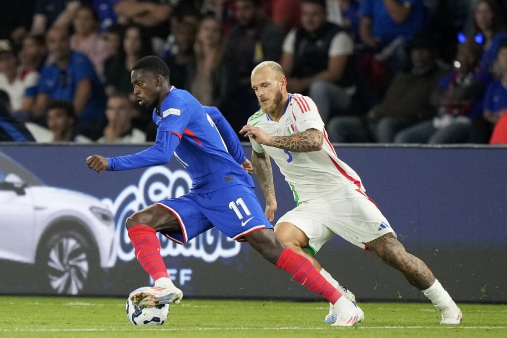 France's Ousmane Dembele runs with the ball away from Italy's Federico Dimarco, right, during the UEFA Nations League soccer match between France and Italy at the Parc des Princes in Paris, Friday, Sept. 6, 2024. (AP Photo/Michel Euler)