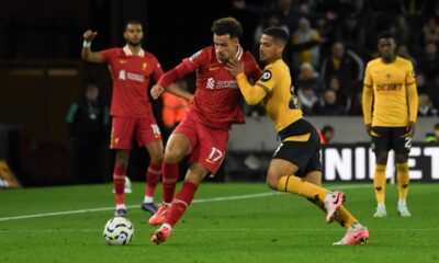 Wolverhampton Wanderers' Joao Gomes, left, and Liverpool's Curtis Jones vie for the ball during the English Premier League soccer match between Wolverhampton Wanderers and Liverpool at the Molineux Stadium in Wolverhampton, England, Saturday, Sept. 28, 2024. (AP Photo/Rui Vieira)