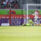 eidenheim's Leonardo Scienza, left, scores his side's second goal during the German Bundesliga soccer match between 1. FC Heidenheim 1846 and FC Augsburg in Heidenheim, Germany, Sunday, Sept. 1, 2024. (Harry Langer/dpa via AP)