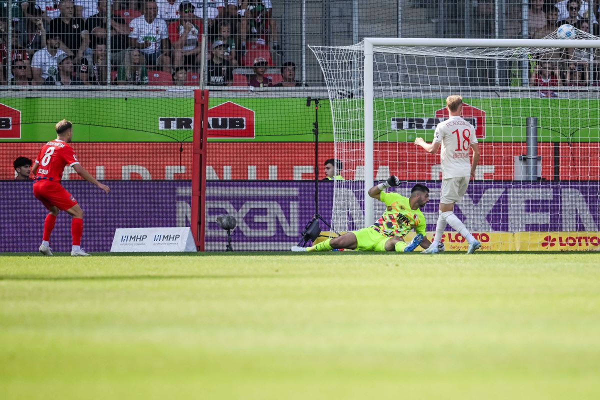 eidenheim's Leonardo Scienza, left, scores his side's second goal during the German Bundesliga soccer match between 1. FC Heidenheim 1846 and FC Augsburg in Heidenheim, Germany, Sunday, Sept. 1, 2024. (Harry Langer/dpa via AP)