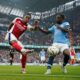 Arsenal's Jurrien Timber, left, clears the ball from Manchester City's Jeremy Doku during the English Premier League soccer match between Manchester City and Arsenal at the Etihad stadium in Manchester, England, Sunday, Sept. 22, 2024. (AP Photo/Dave Thompson)