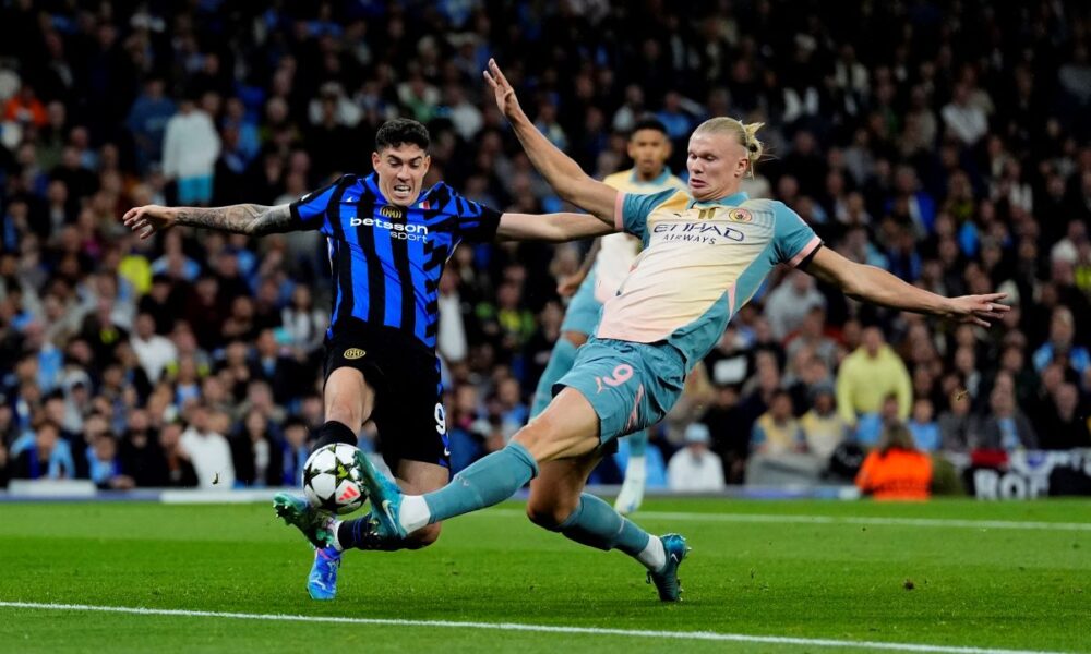 Manchester City's Erling Haaland, right, and Inter Milan's Alessandro Bastoni, left, challenge for the ball during the Champions League opening phase soccer match between Manchester City and Inter Milan in Manchester, England, Wednesday, Sept. 18, 2024. (Nick Potts/PA via AP)