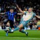 Manchester City's Erling Haaland, right, and Inter Milan's Alessandro Bastoni, left, challenge for the ball during the Champions League opening phase soccer match between Manchester City and Inter Milan in Manchester, England, Wednesday, Sept. 18, 2024. (Nick Potts/PA via AP)