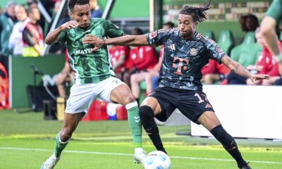 Werder's Felix Agu, left, and Bayern's Michael Olise, right, challenge for the ball during the German Bundesliga soccer match between SV Werder Bremen and Bayern Munich in Bremen, Germany, Saturday, Sept. 21, 2024. (Sina Schuldt/dpa via AP)